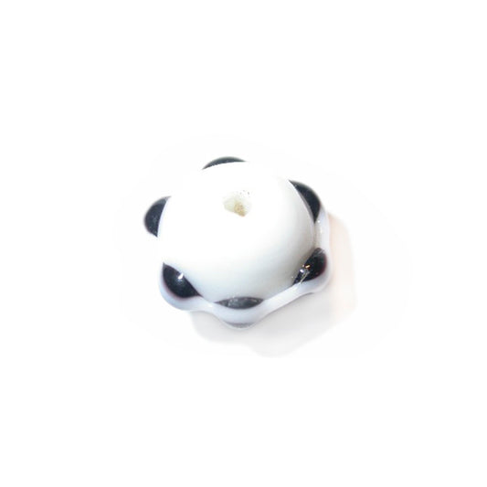 White glass bead with collar with black dots on it