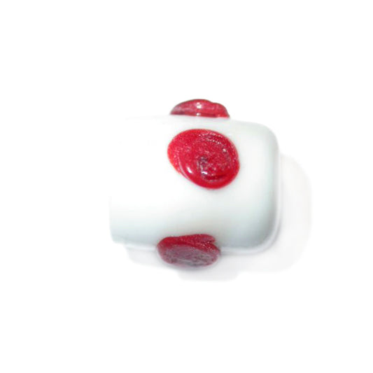 White cylinder of glass with red dots