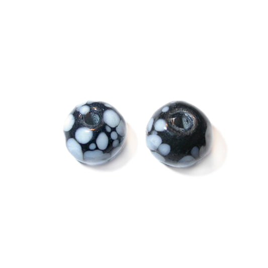 Black, round glass bead with white dots