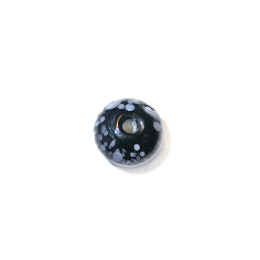 Black, discusform glass bead with white dots