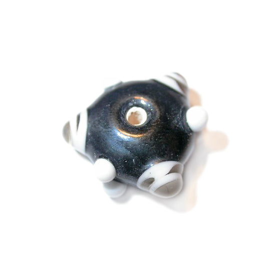 Black glass bead with white and grey dots