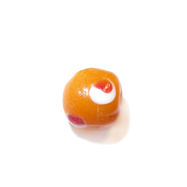 Round orange glass bead with white and red dots