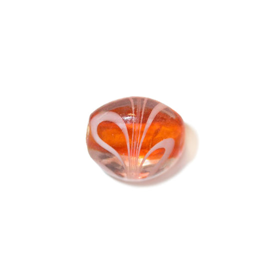 Transparent glass bead with orange inside and white stripes