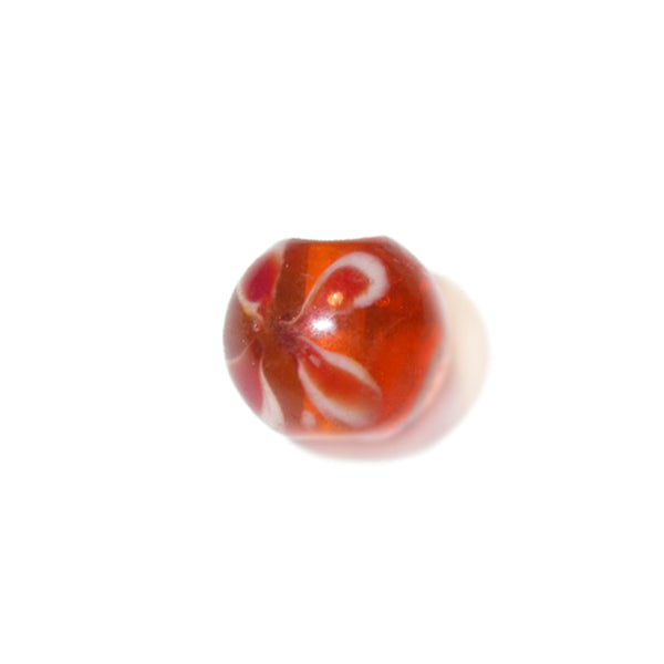 Orange glass bead with inside flower drawings