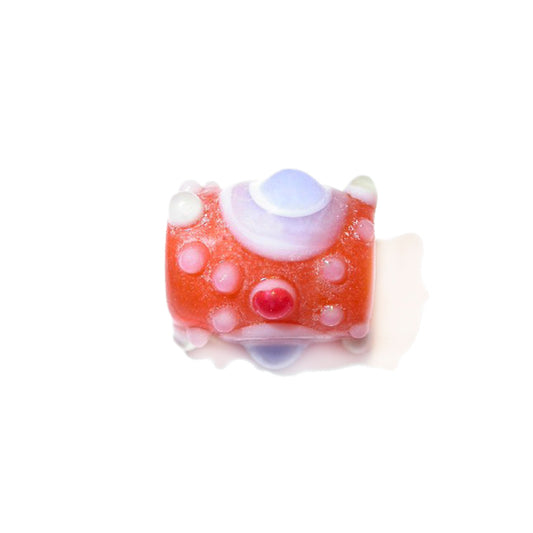 Orange glass bead with white and coloured dots