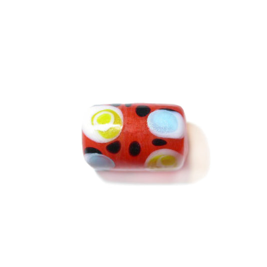 Orange cilinderform glass bead with dots