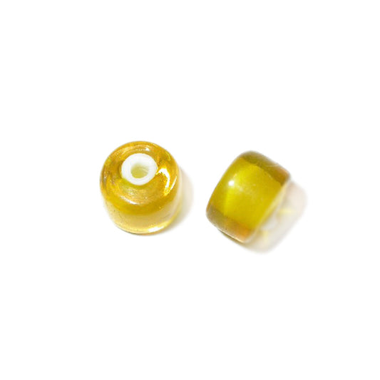 Yellow, halfround, transparent glass bead with white inside