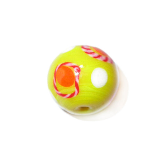 Yellow, round bead made of glass