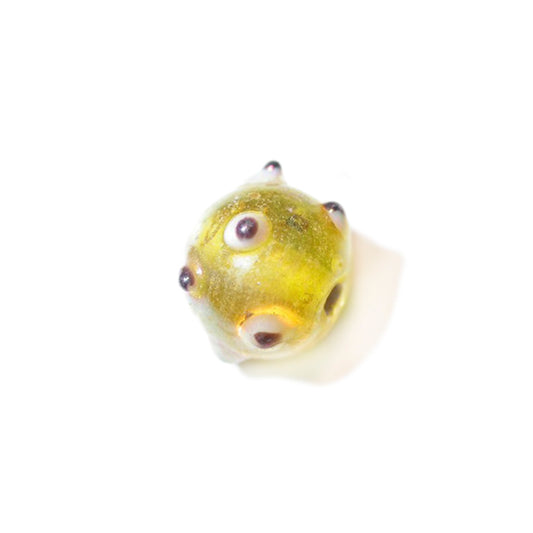 Yellow glass bead wiht Black/white dots