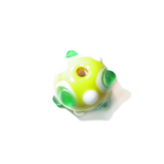 Yellow handmade glass bead with white and green dots