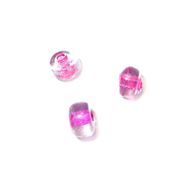 Transparent glass bead with fuchsia inside