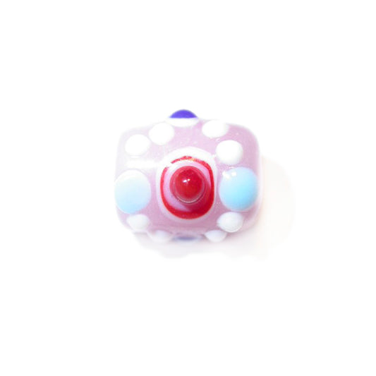 Pink glass bead with white and colored dots