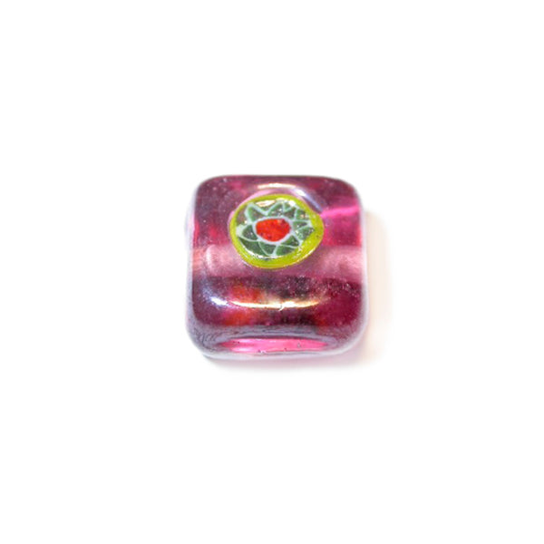 Square pink glass bead with yellow and blue drawing