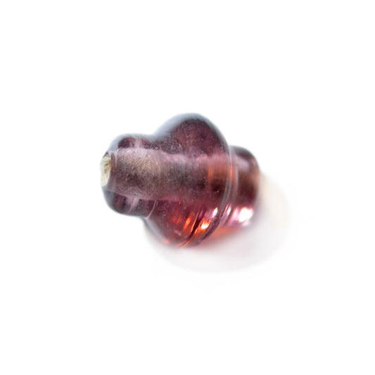 Purple glass bead with a belly in the middle of the bead