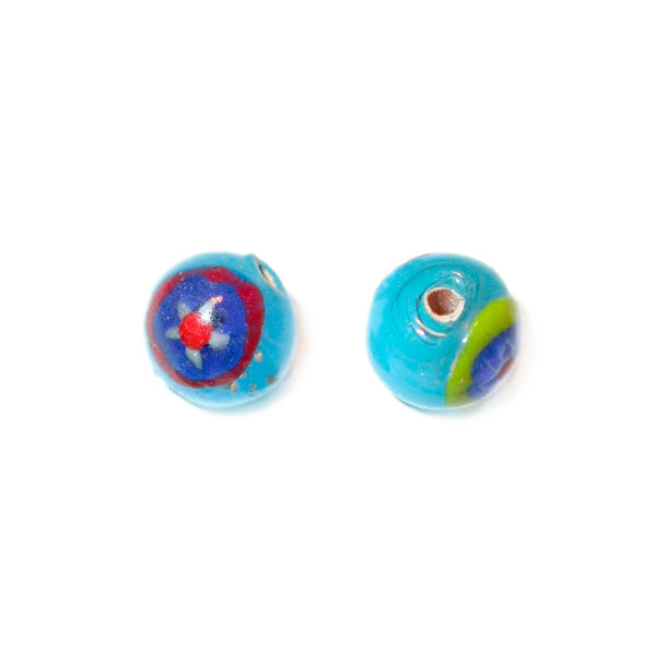 Blue round glass bead with colored drawings