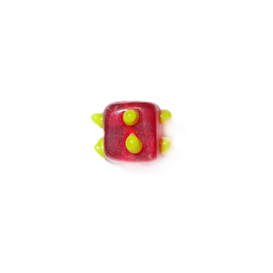 Red, square glass bead with yellow dots