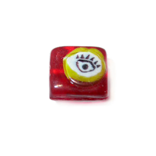 Red, square glassbead with white and yellow drawing