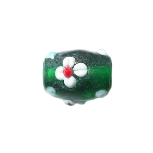 Green glass bead decorated with white flowers and blue dots