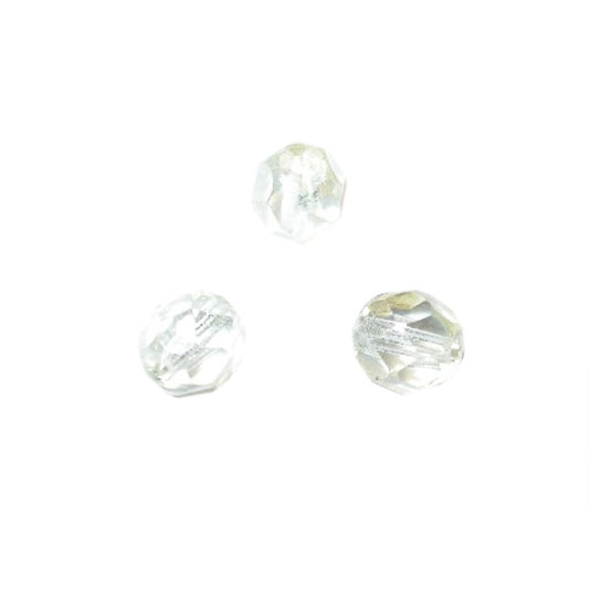 Transparent faceted glass bead with a bit of a yellow glow