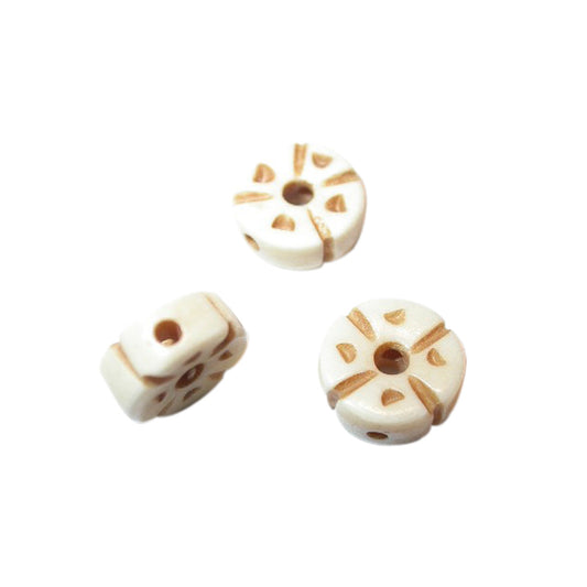 Cream coloured bone bead with decoration