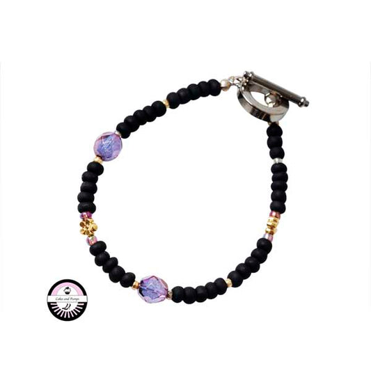 Bracelet with black, gold colored and purple beads